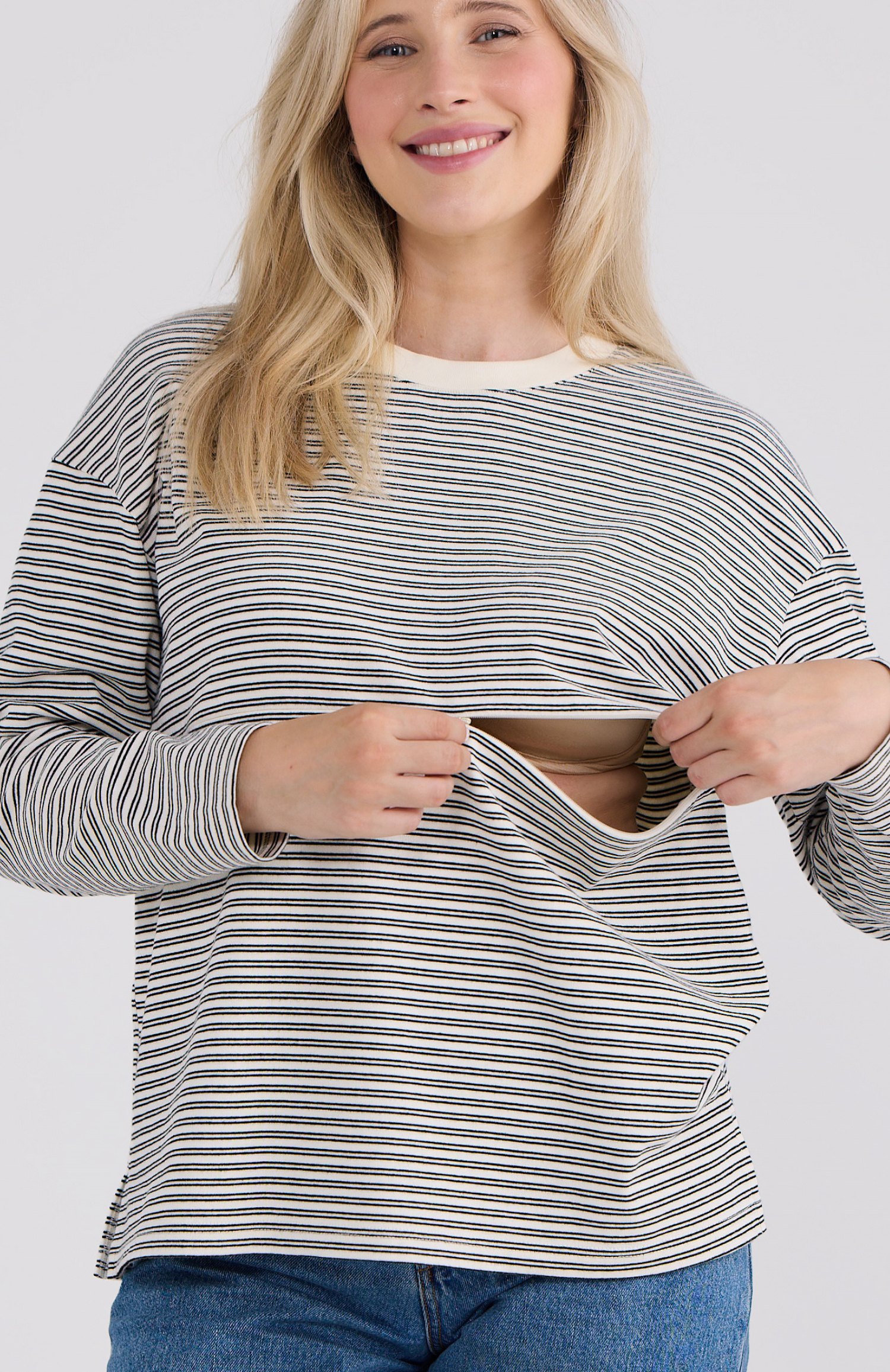 Woman wearing a striped shirt with a breastfeeding zip.