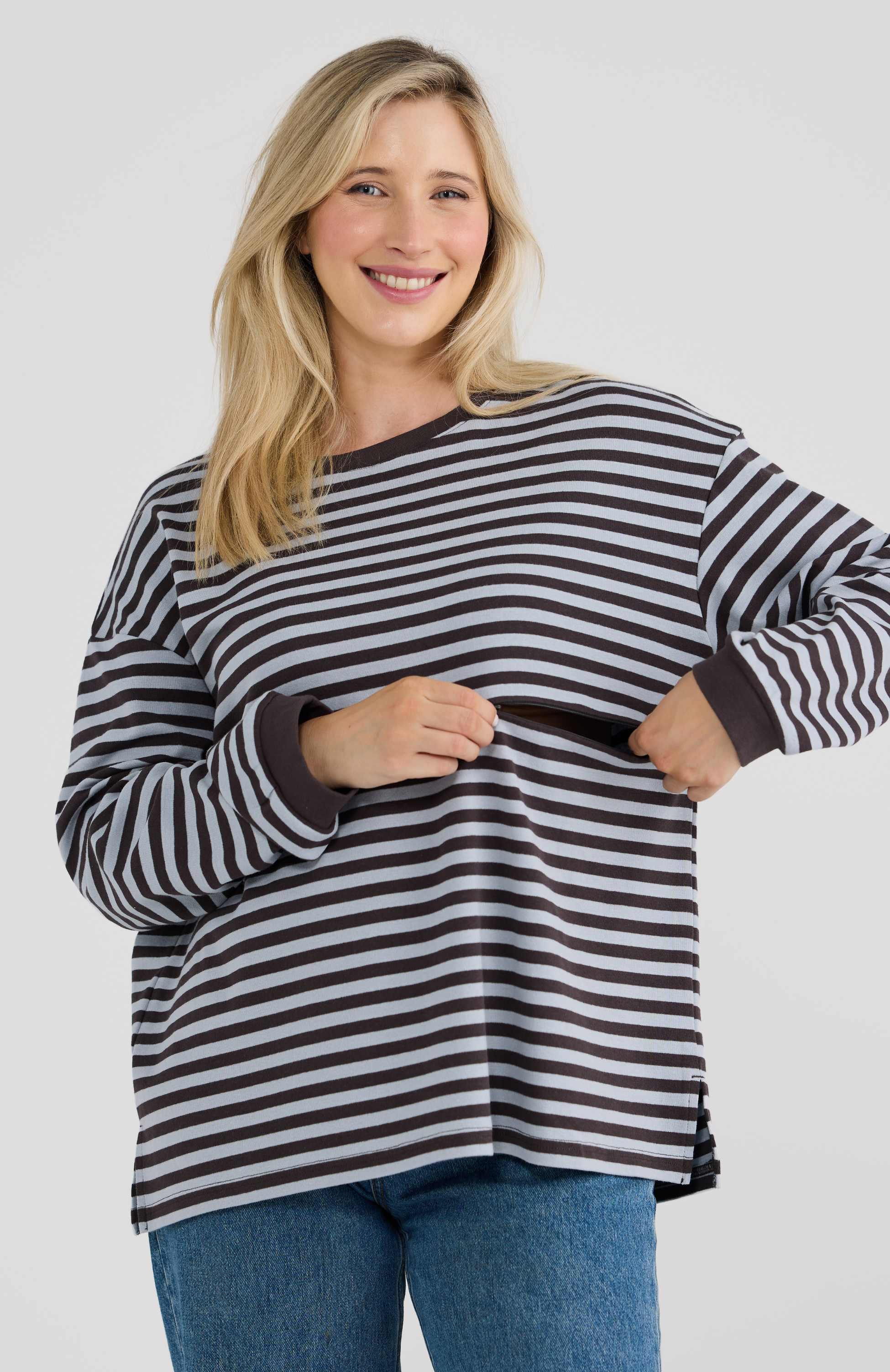 Woman wearing a Blue striped sweater on a plain background