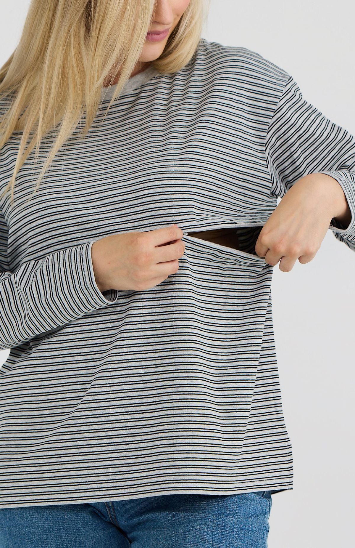 Person wearing a striped long-sleeve shirt with a white background