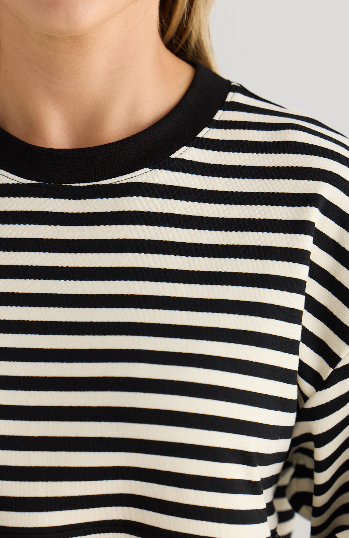 Close-up of a black and white striped shirt with a blurred background