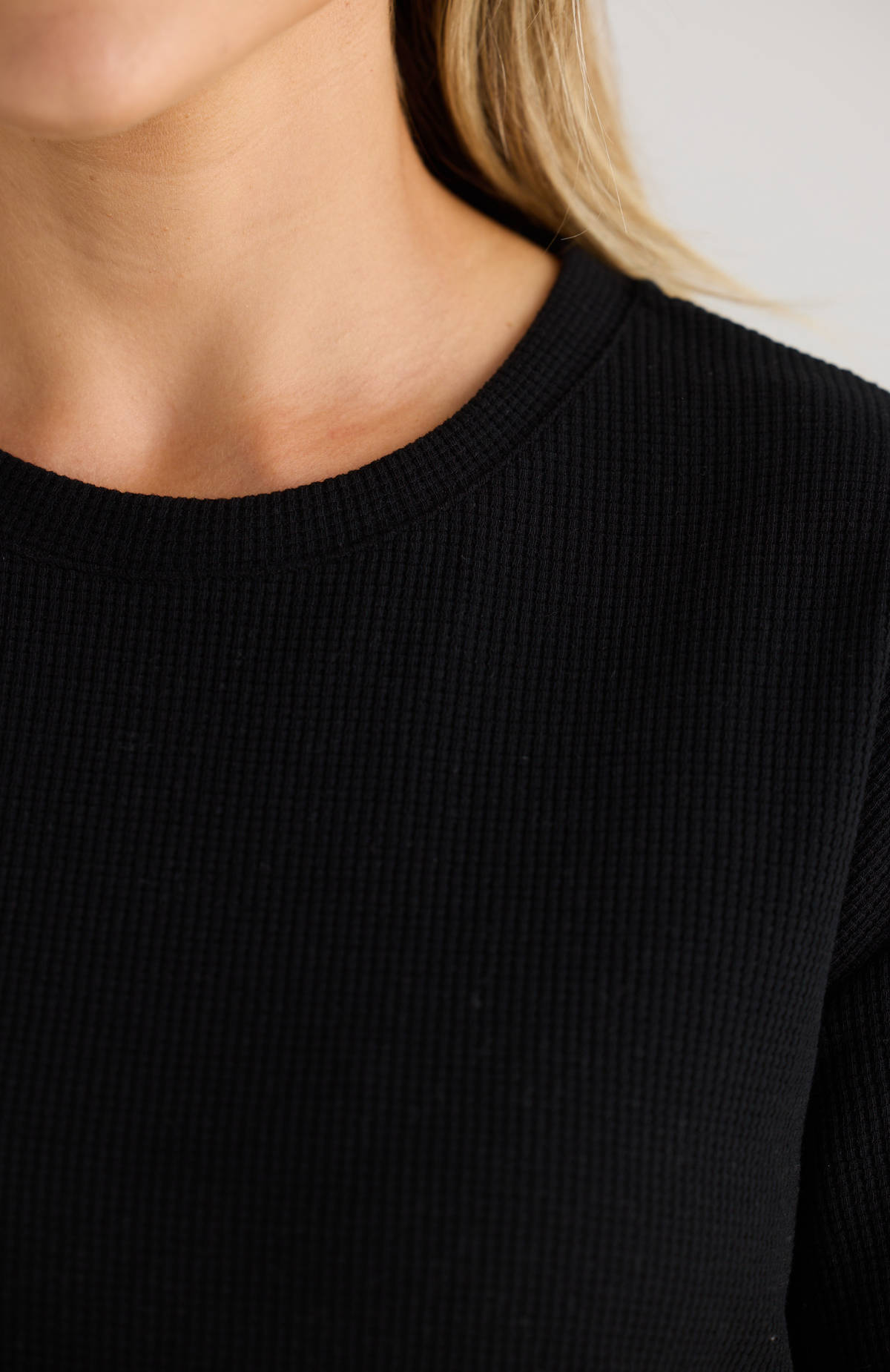 Close-up of a person wearing a black breastfeeding T-Shirt